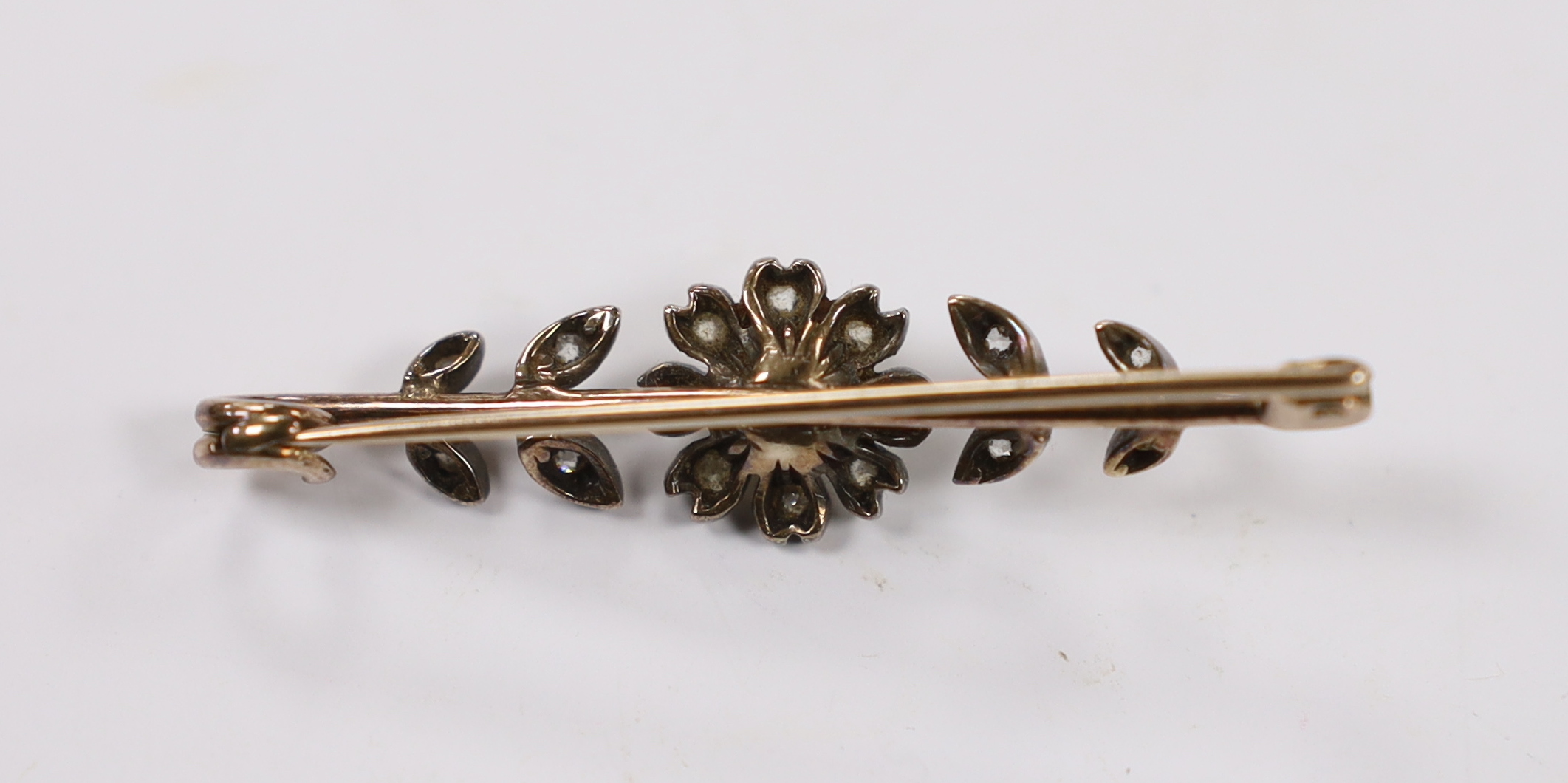 A late Victorian yellow and white metal, seed pearl and diamond cluster set flower head bar brooch, 44mm, gross weight 3.5 grams.